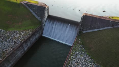 drone flying over reservoir and kayaker at sunset