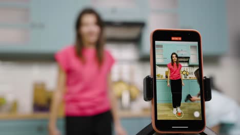 teenage girls dancing and vlogging in a kitchen