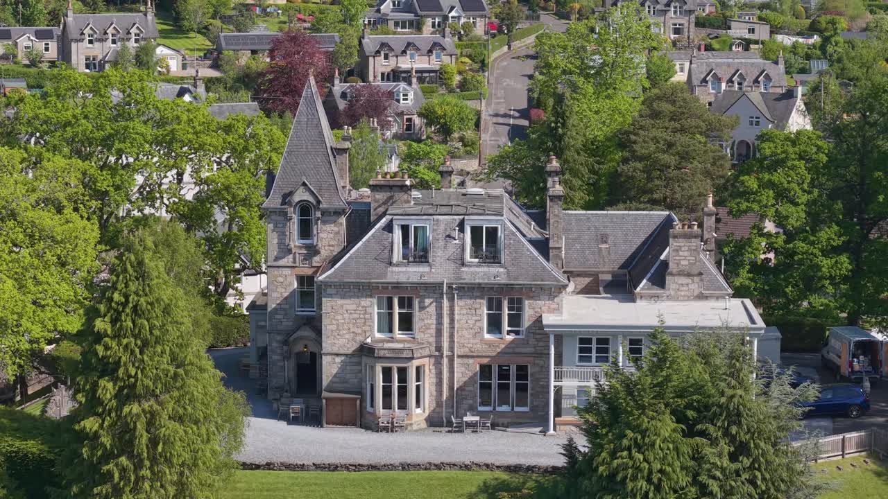 Revealing the top roof of a mansion house in Pitlochry, Scotland, showcasing its historic architecture and surrounding scenic highland landscapes