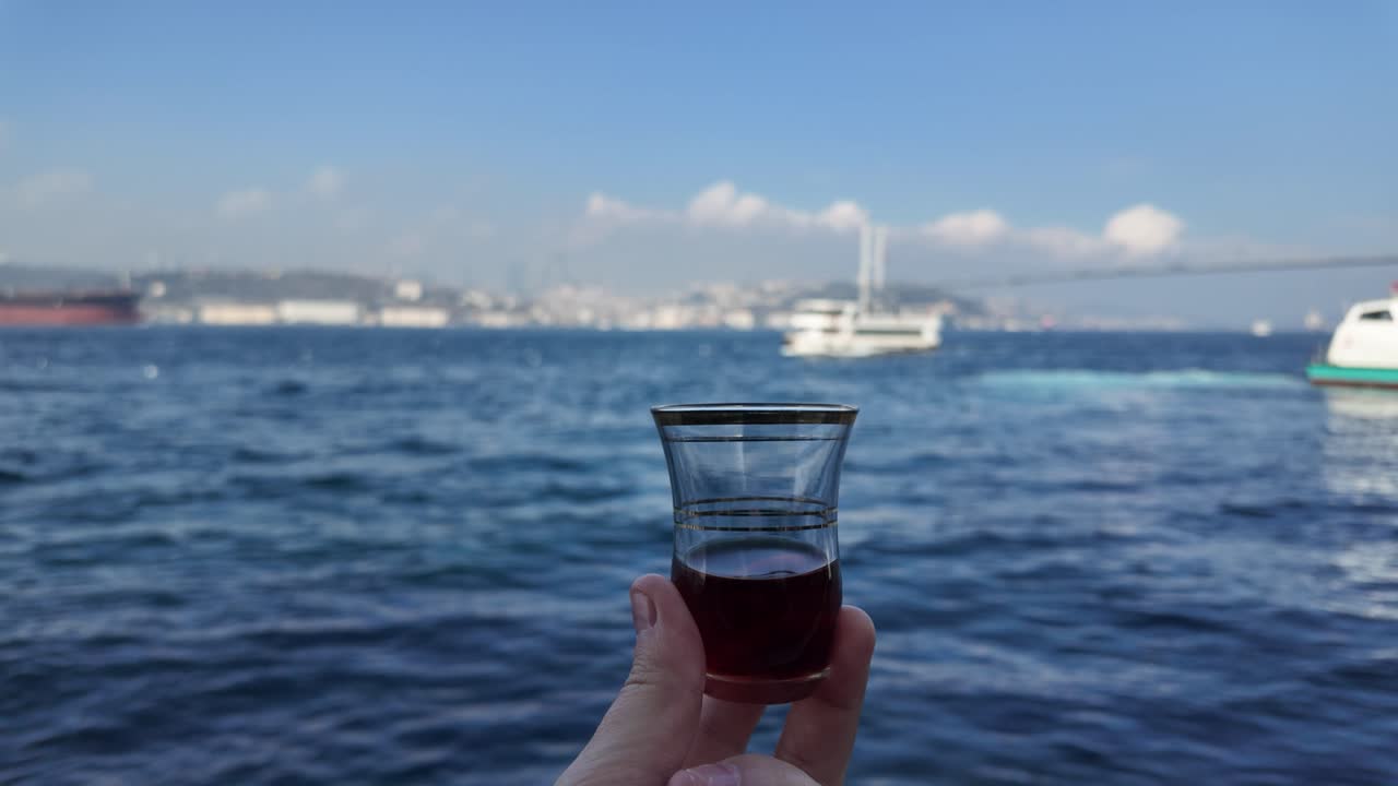 Turkish tea glass with Bosphorus and bridge in background in Istanbul