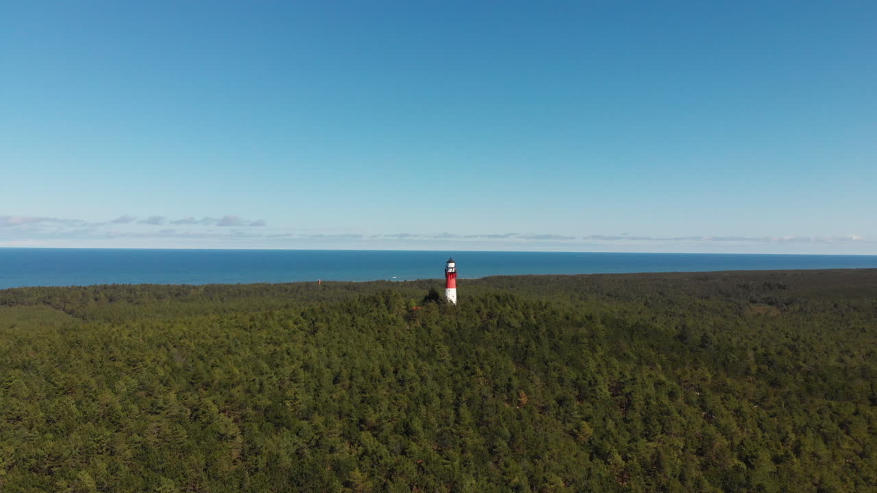 Red and white lighthouse in the forest