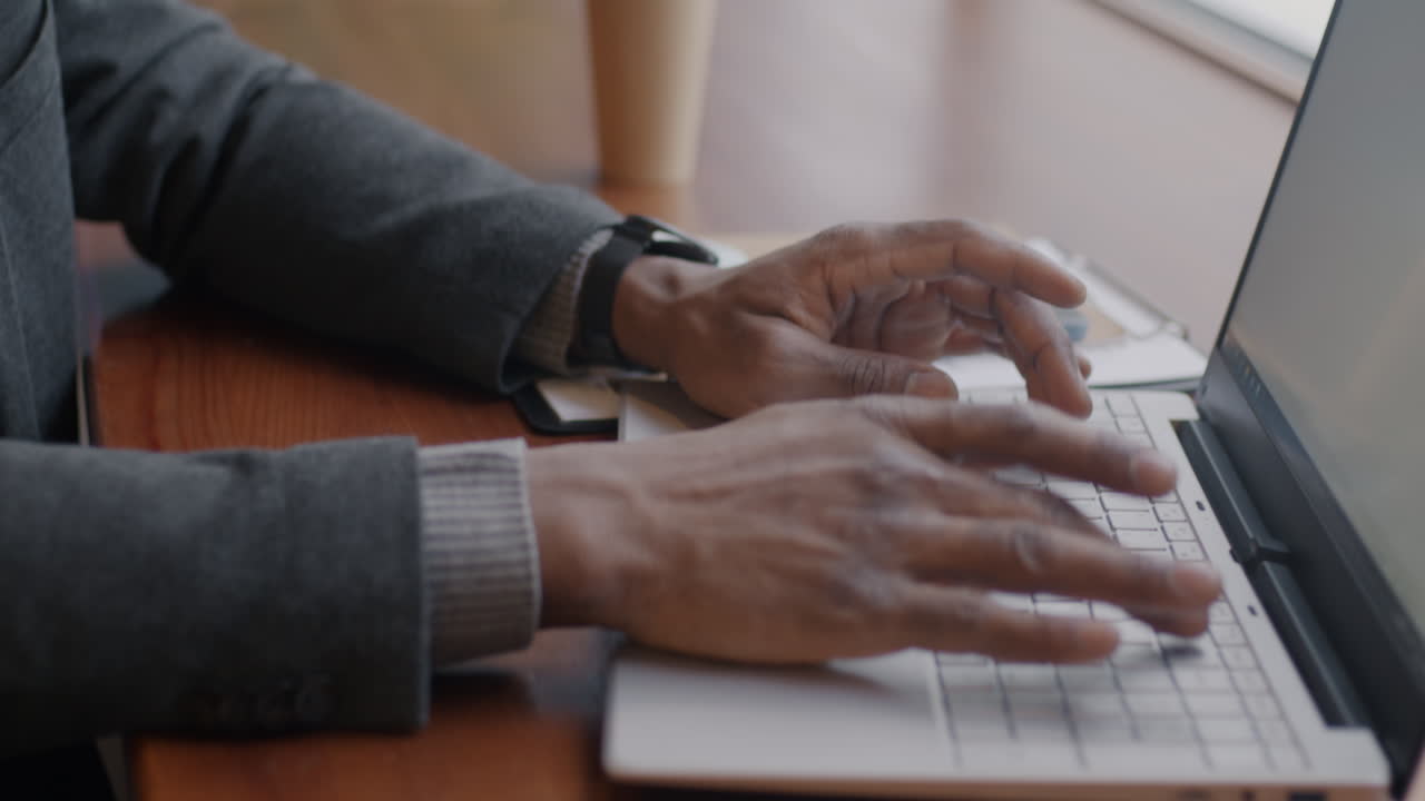 Businessman working on laptop in a cafe