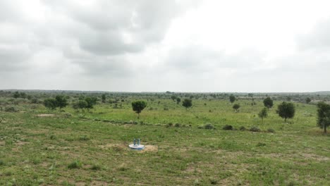 Aerial-drone-forward-moving-shot-over-large-millet-fileds-in-Tharparkar,-Pakistan-on-a-cloudy-day