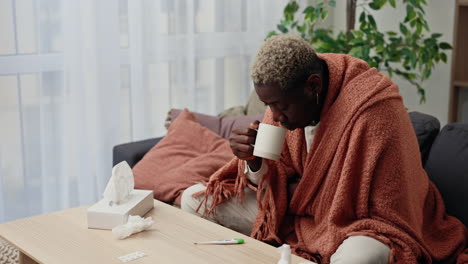 sick person drinking warm drink