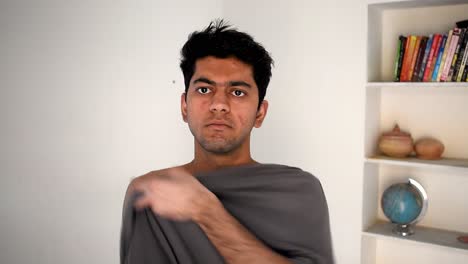 young-man-getting-dressed-wearing-T-shirt