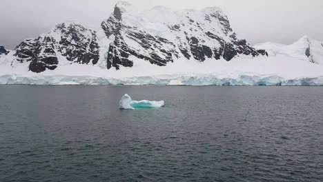 small iceberg floating on dark water small iceberg floating on dark water