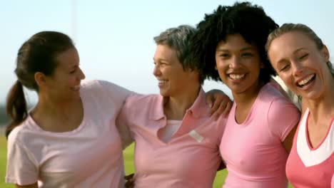 smiling women wearing pink for breast cancer