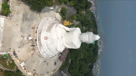 Vertical-aerial-view-of-Phuket-Big-Buddha,-or-The-Great-Buddha-of-Phuket,-is-a-seated-Maravija-Buddha-statue-in-Phuket,-Thailand