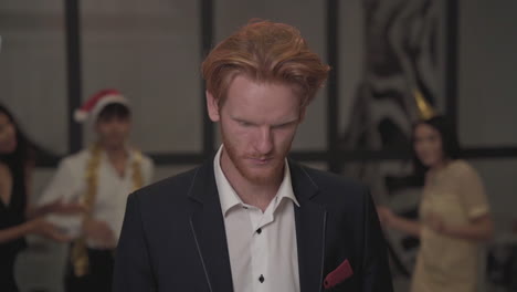 young red-haired man looking at the camera