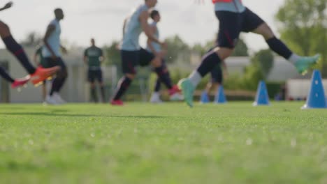 low angle slow motion shot of out focus soccer players jogging