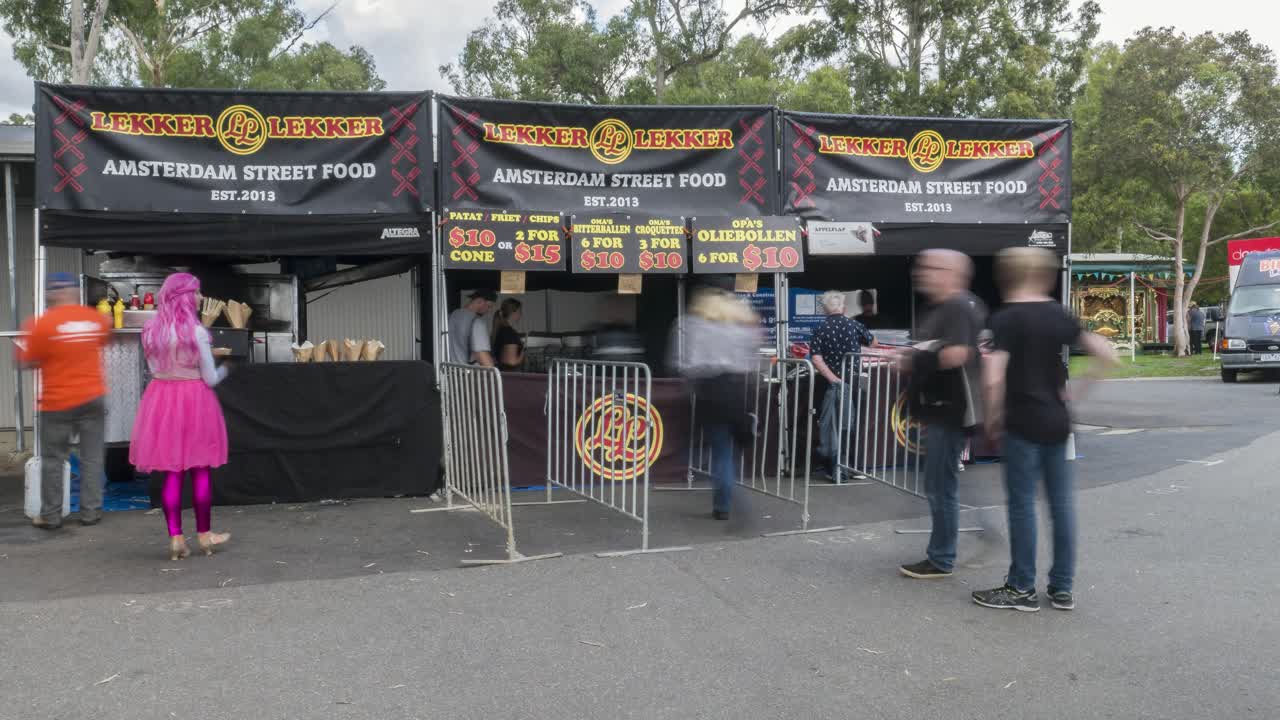 Timelapse of people outisde a street food vendor at the Holland Festival in the outer suburbs of Melbourne, Victoria, Australia, March 2020.