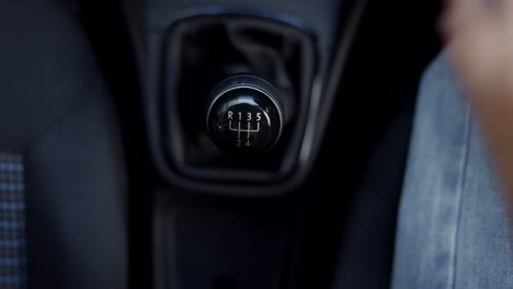 Hand,-gear-and-a-person-driving-a-car-closeup