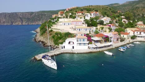 drone shot retreating and panning to the left side of the frame of a peninsula at agriosiko beach, a secret getaway located in the island of kefalonia in western greece