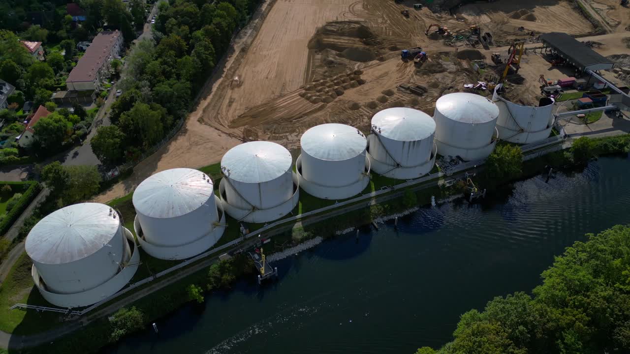 Decommissioning of Storage depot for petroleum products storage silos and containers. Industrial storage tanks holding oil and gas products. Lovely aerial view flight panorama orbit drone