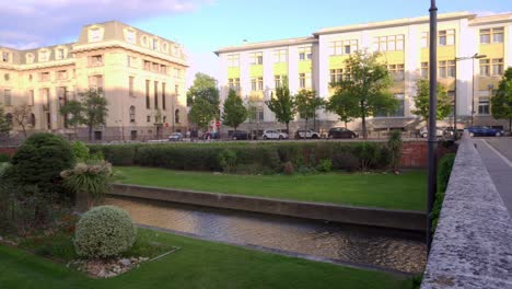 Panning-shot-of-Perpignan-city-center-with-a-canal-on-a-windy-summers-day