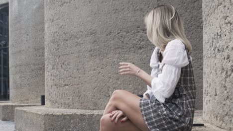 Slow-motion-shot-of-women-sitting-down-and-crossing-her-legs