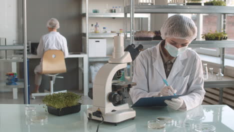 scientists conducting plant-based experiment in a lab