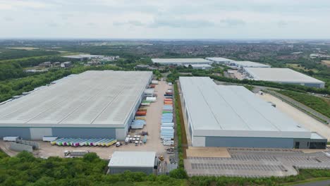 drone cinematic aerial close orbit footage of modern warehouse and logistics distribution centre with bays kettering england uk