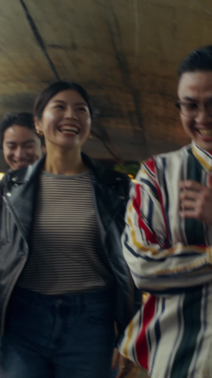 Friends Walking Through a Tunnel at Night