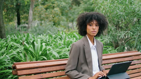 Girl-freelancer-working-park-close-up.-African-american-woman-typing-on-computer