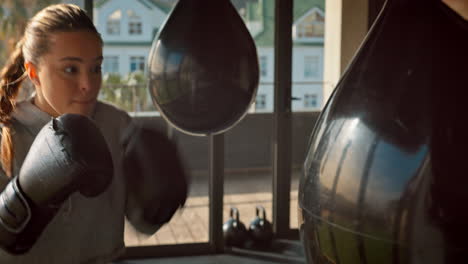 boxer, woman and punching bag for exercise