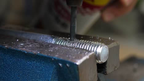 close up of professional craftsman lubricating drill