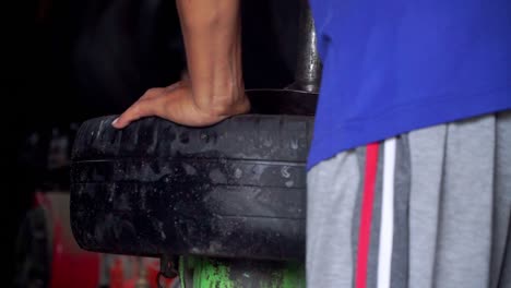 close up shot of the process of removing car tyre from the rim manually