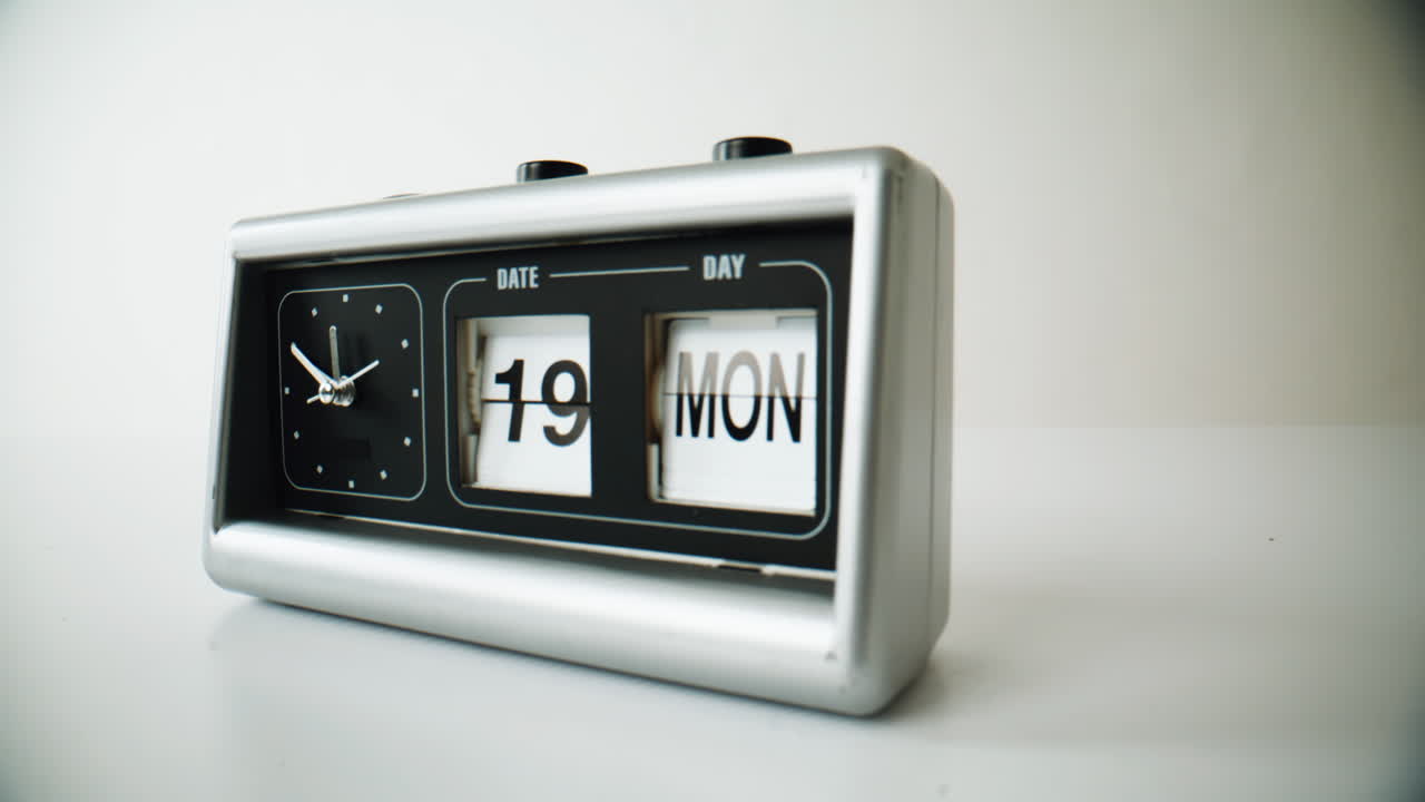 Classic flip clock standing at white surface closeup. Traditional timepiece