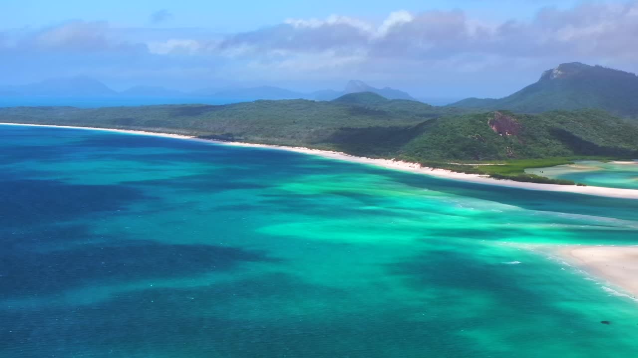 Whitehaven Beach sailboat sunny mid day summer aerial drone picturesque sandy reef Whitsundays Islands North end Hill Inlet Lookout Aussie National Park scenic flight view pan left