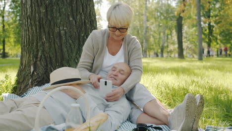 happy senior couple enjoying a picnic in the park