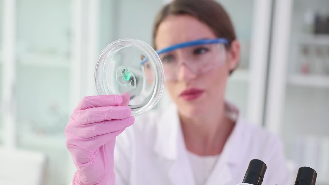 Scientist examining a petri dish in a laboratory