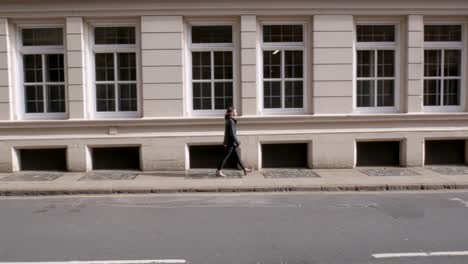 attractive woman walking along the opposite side of the road