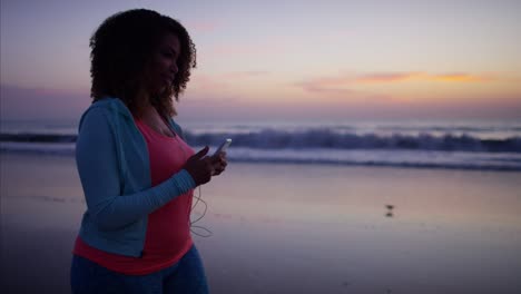 voluptuous ethnic female exercising gently with wearable technology