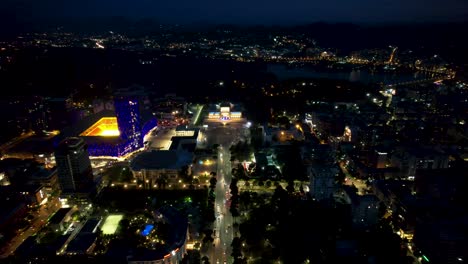 tirana's nocturnal splendor: capital city at night, illuminated buildings, and boulevard ablaze with vibrant lights - urban elegance