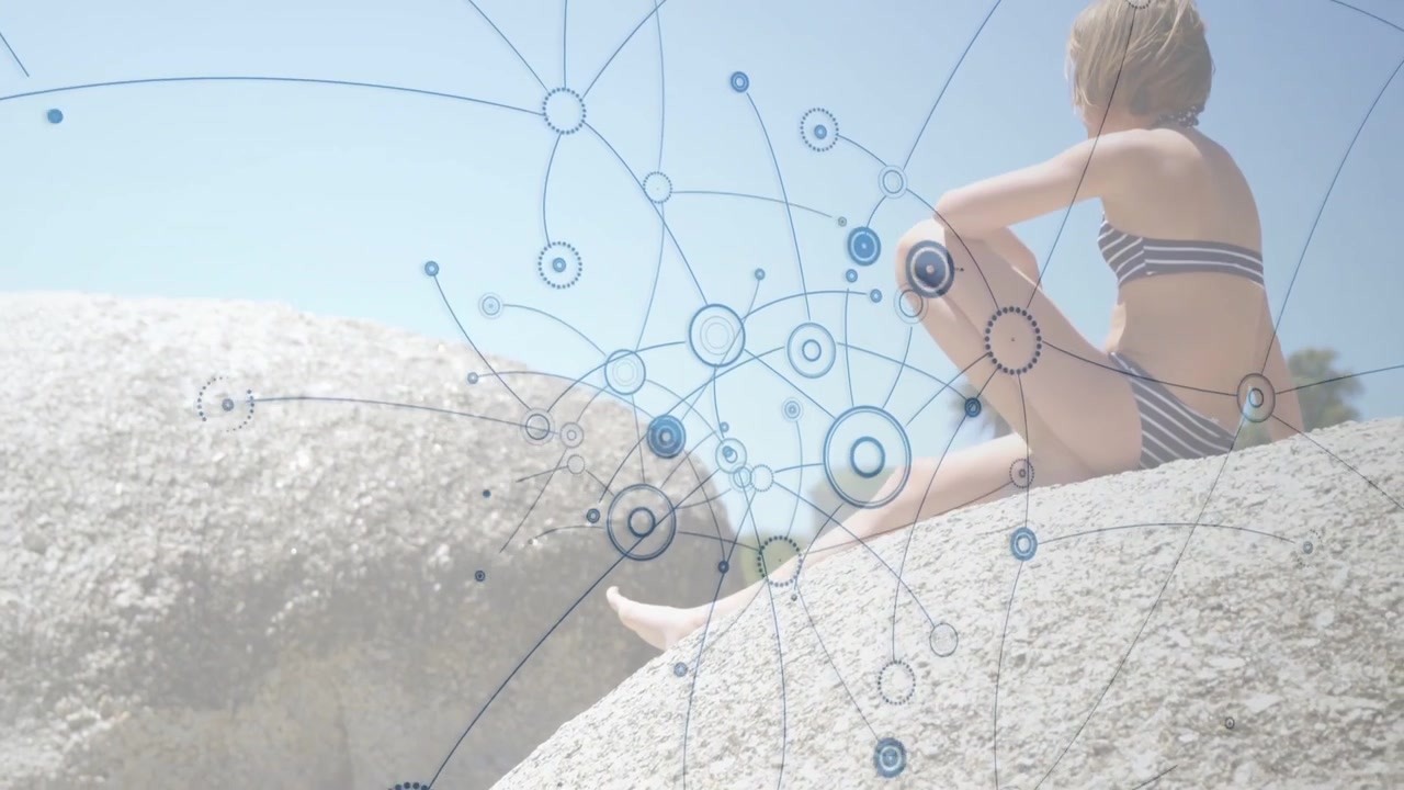 Girl sitting on rock, blue network appearing and expanding, overlaying torso and showing technology
