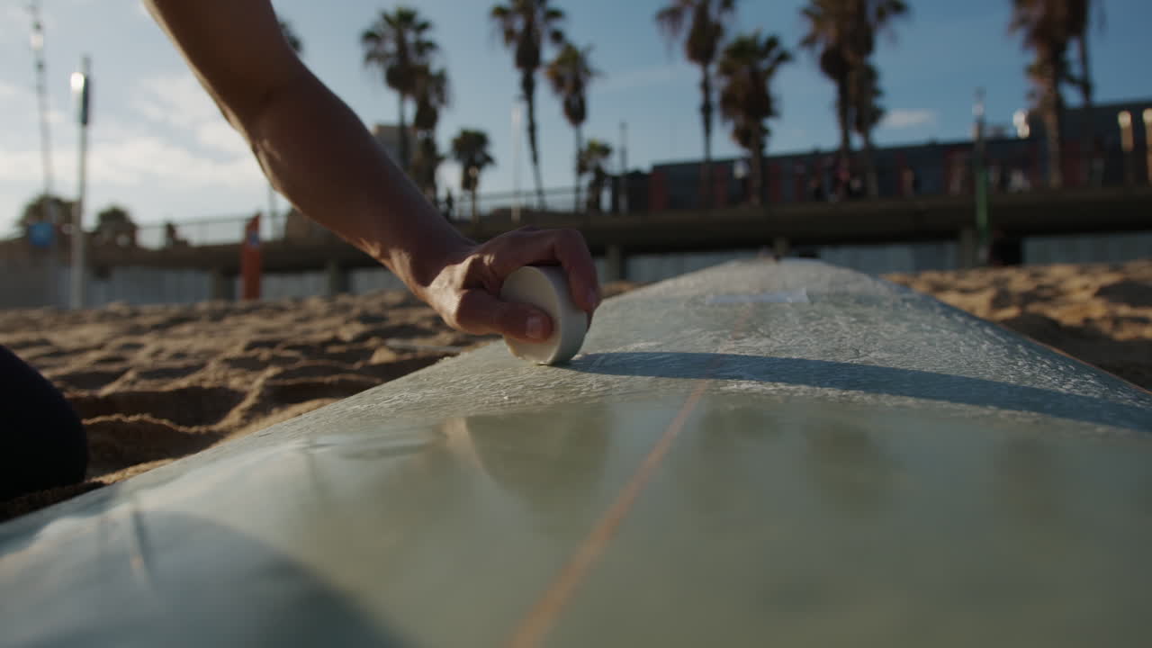 Surfer man walking to the beach at sunset preparing for surfing training and search for waves in Barcelona, spain, water, ocean exercise in sea with board, athletic male holiday or travel in vacation
