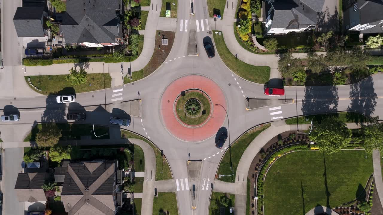 Traffic Over The Roundabout In Willoughby Suburban Area In The Township Of Langley, British Columbia, Canada. Aerial Topdown Shot
