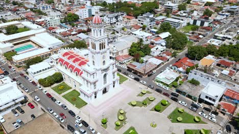 aerial orbiting shot of sacred heart of jesus church in moca, dominican republic