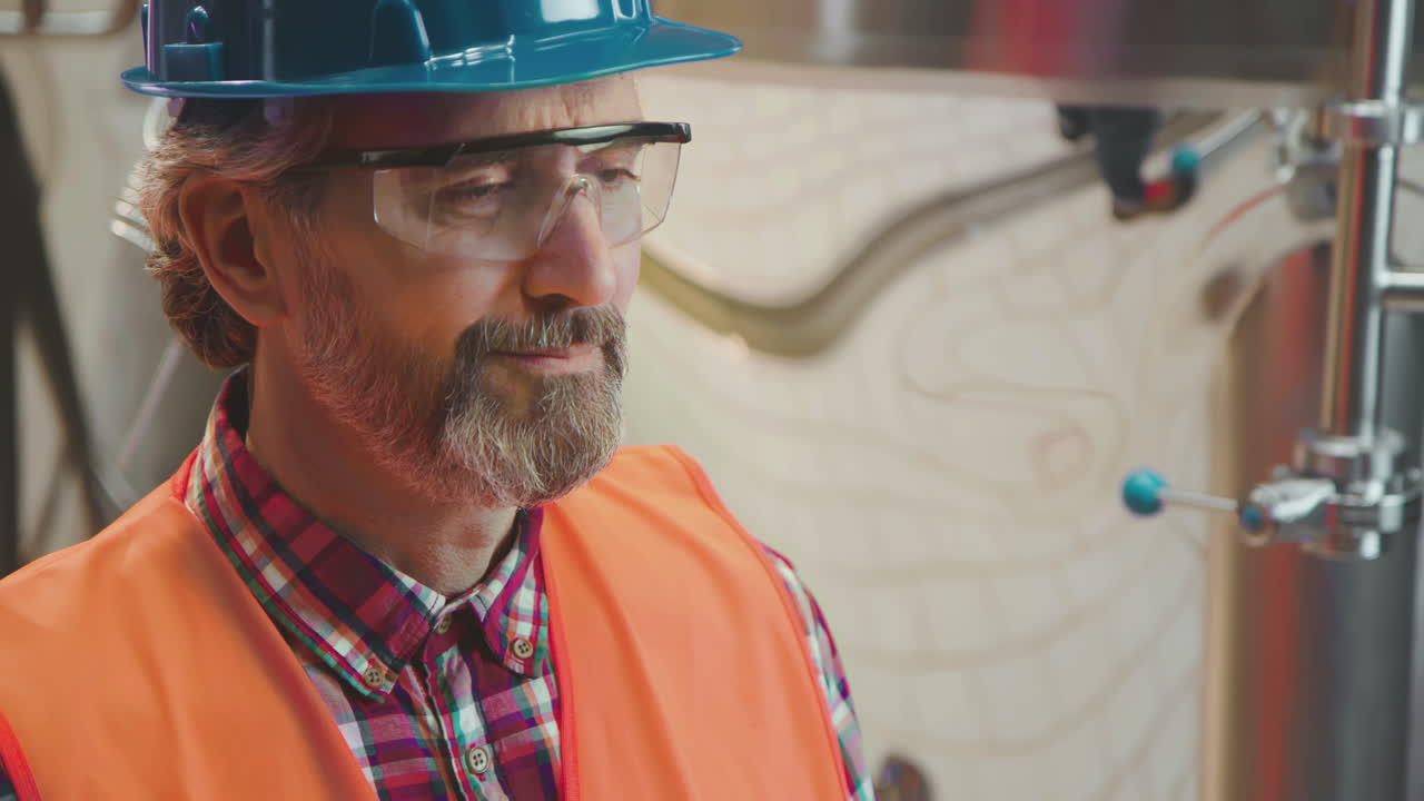 Engineer in Hard Hat Inspecting Equipment