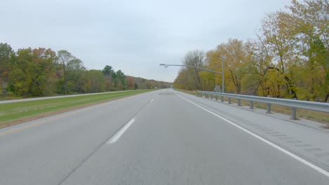 pov while driving past the weigh station on a straight portion of interstate i280 in the rock river flood plain a cloudy day in early winter near moline, illinois