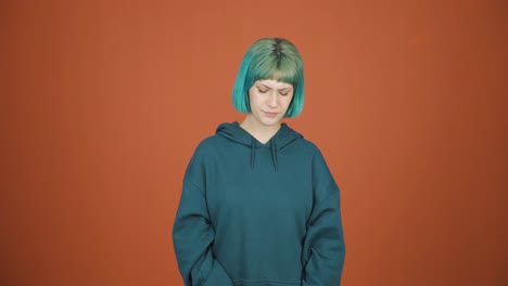 penniless young woman looking at her empty wallet.