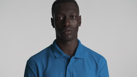 serious african american man on grey background.