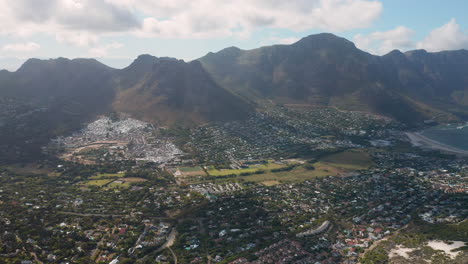 vista panorámica de sandy bay, houtbay en la distancia en sudáfrica - toma aérea giratoria