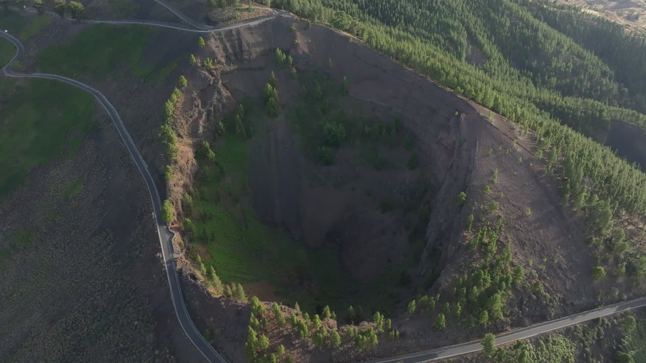Aerial view of Caldera de Los Pinos de Galdar and surrounding pine trees in Gran Canaria, Canary Islands, Spain