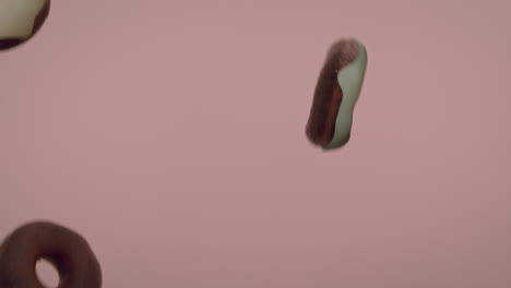 white glaze donuts on a light pink background