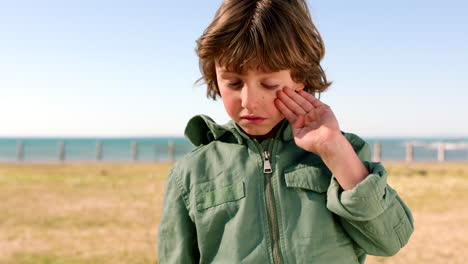 Travel,-tired-and-face-of-child-at-beach-exhausted