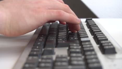 man typing on computer keyboard