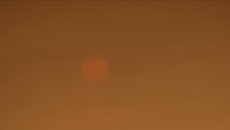 time lapse of sun setting behind smokey skies