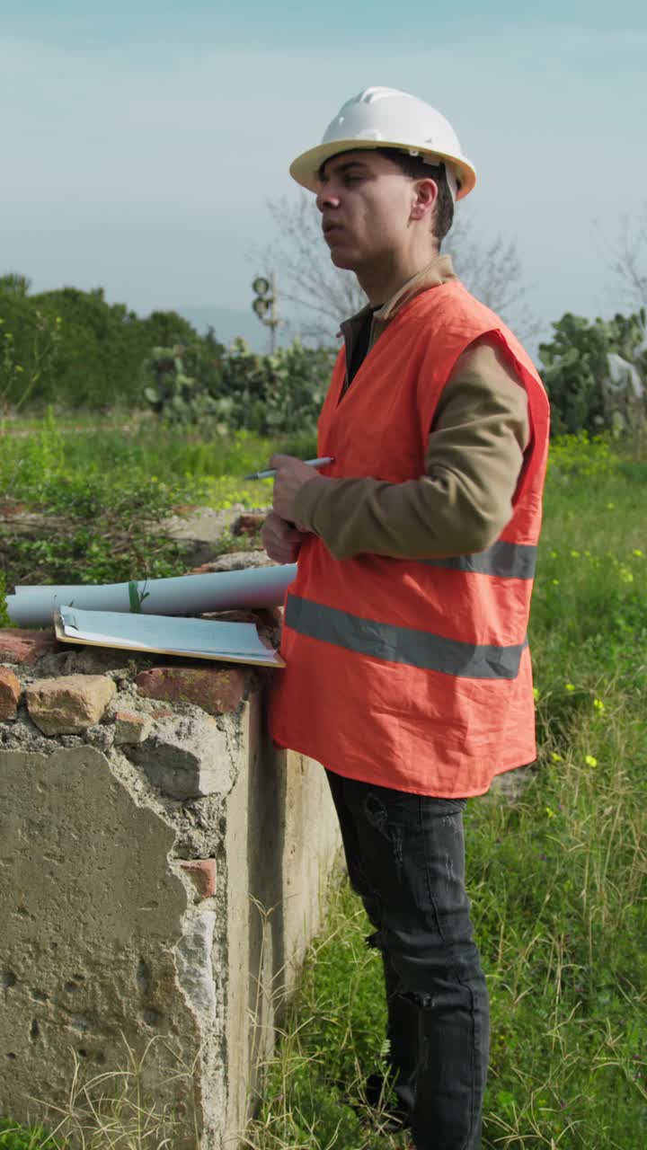 Construction Worker With The Helmet In The Nature Reading The Project Document