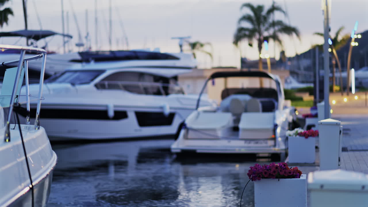 Blurred view of multiple white boats docked in the Port Vauban at sunset in Antibes, France